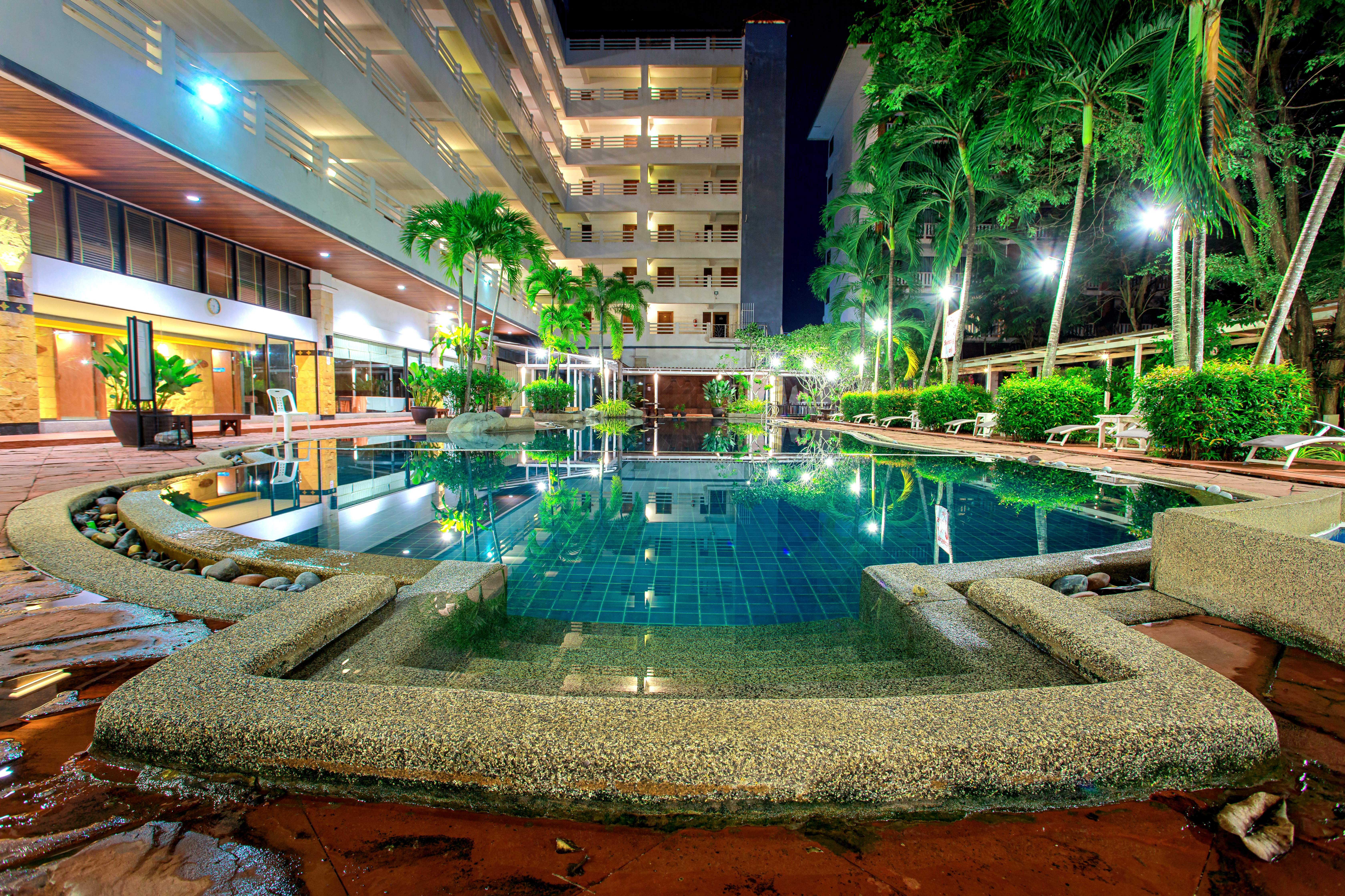 Outdoor swimming pool surrounded by gardens
